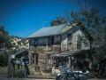 Motorcycle and rustic home, Madrid, New Mexico